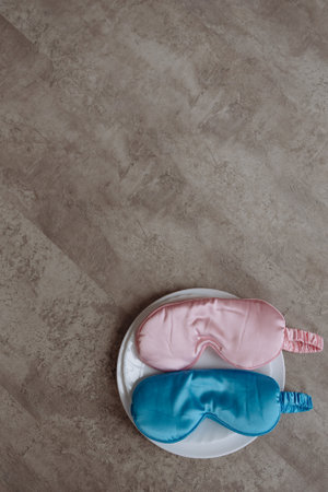 Two blue and pink eye masks on white plate. Gender party accessories.の写真素材