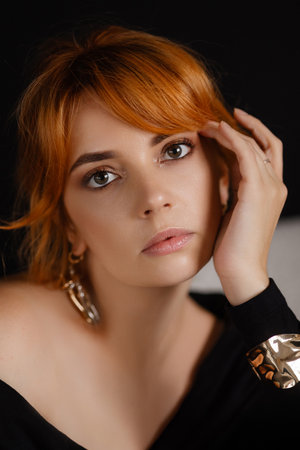 Close-up portrait of a young woman with bright red hair