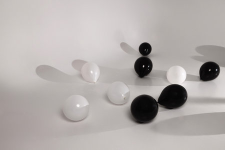 Minimalist Black and White Balloons on a Neutral Backgroundの写真素材