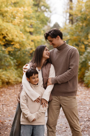 Happy Family Walking in Autumn Parkの写真素材