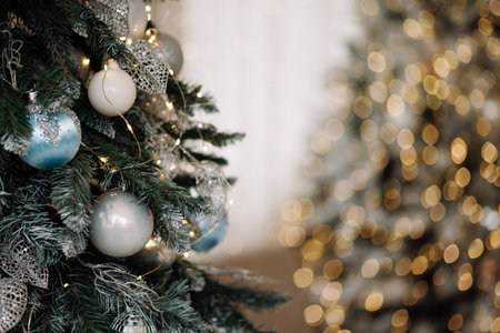 Christmas tree with silver and blue ornaments and fairy lights with copy spaceの写真素材
