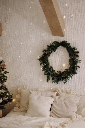 Scandi loft bedroom with Christmas tree and wreath on white textured wallの写真素材