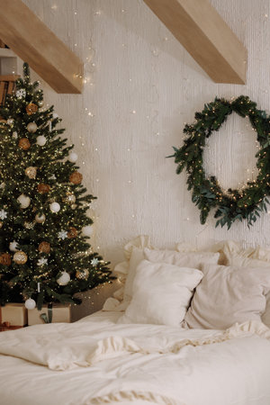 Scandi loft bedroom with Christmas tree and wreath on white textured wallの写真素材