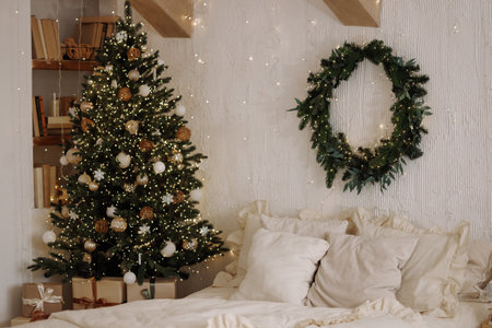 Scandi loft bedroom with Christmas tree and wreath on white textured wallの写真素材