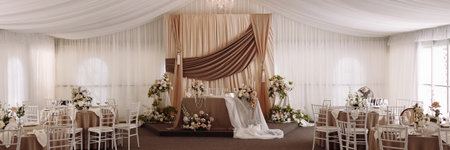Banner wedding banquet hall with elegant stage and round tables decorated in beigeの写真素材