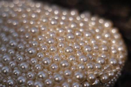 Close-up of a decorative mound of pearl beads on a dark blurred background