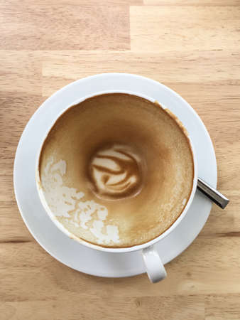 Top view a cup of coffee on wooden table backgroundの写真素材