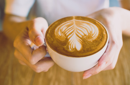 Cup of coffee latte in coffee shopの写真素材