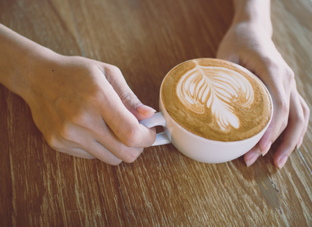 Cup of coffee latte in coffee shopの写真素材