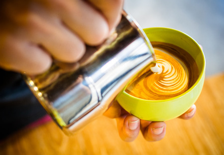 coffee latte art cup in cafeの写真素材