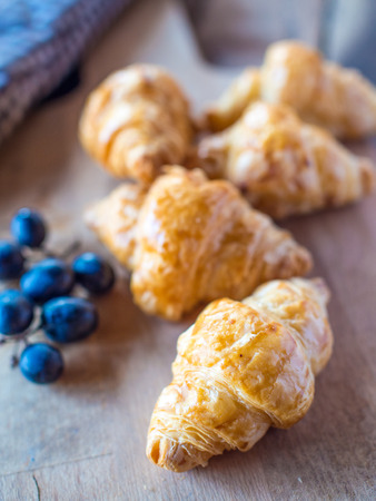 Tasty croissants with spikelets on grey wooden backgroundの写真素材