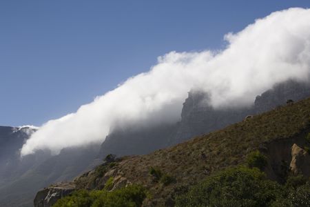 White mist clouds rolling in over maountainの写真素材