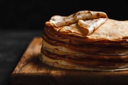 Maslenitsa Maslenitsa week is a holiday of food. A stack of Russian pancakes on a dark rustic wooden background. Front view with copy spaceの写真素材