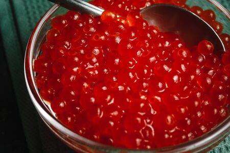 Maslenitsa Maslenitsa week is a holiday of food. Pancakes with red caviar on a plate with Cutlery. The view from the top. side view. space for textの写真素材