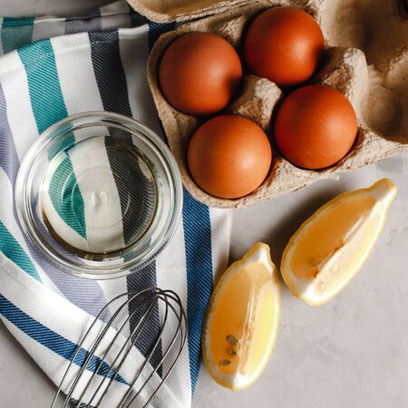 Ingredients for making pancakes. chicken eggs, whisk, flour, sugar, lemon. the view from the top place for textの写真素材