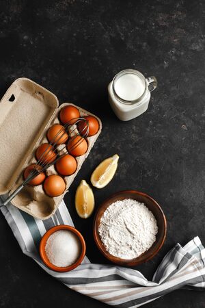 Ingredients for making pancakes. chicken eggs, whisk, flour, sugar, lemon. the view from the top place for textの写真素材