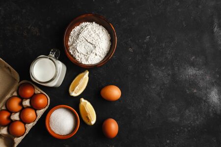 Ingredients for making pancakes. chicken eggs, whisk, flour, sugar, lemon. the view from the top place for textの写真素材