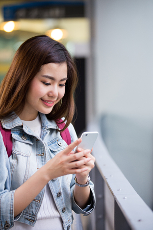 Young Asian Girl holding her phoneの写真素材