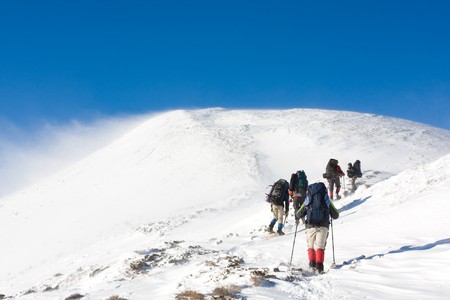Hiker are in winter in mountainsの写真素材