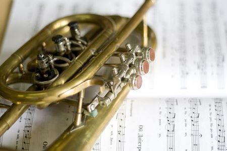 Trumpet on musical notes as background close upの写真素材
