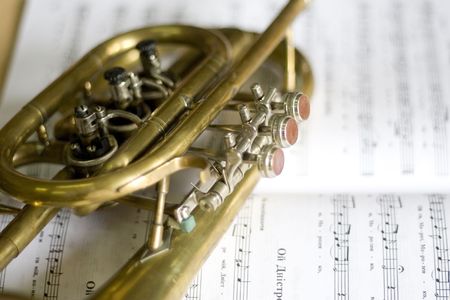 Trumpet on musical notes as background close upの写真素材