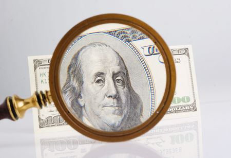 Dollars and magnifying lens