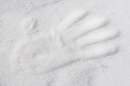 hand print in fresh snowの写真素材