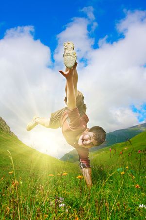 Boy dances on the meadowの写真素材
