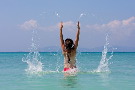 girl with long hair playing in the seaの写真素材