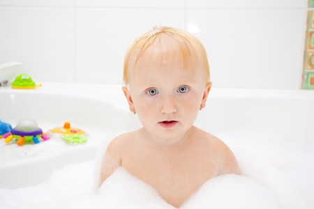 A baby girl in a bathtubの写真素材