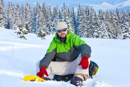 Hiker took a rest in snow forestの写真素材
