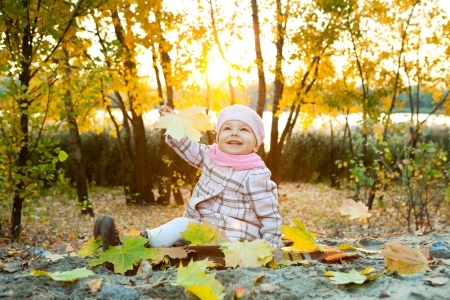 girl with autumn leaves in the beauty parkの写真素材
