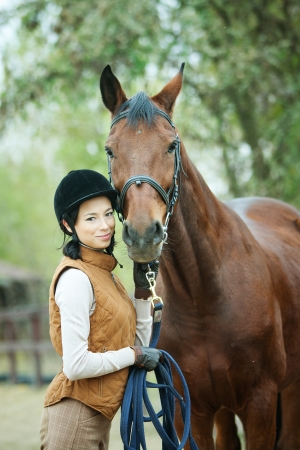 Woman jockey is riding the horse outdoor
の写真素材