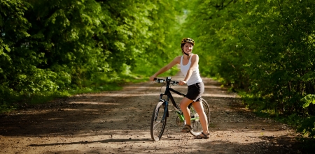 Biker on the forest road の写真素材