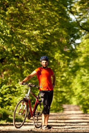 Biker on the forest road の写真素材