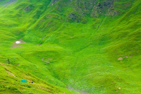Green tent on meadow between mountains, Georgiaの写真素材