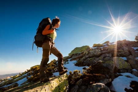Hiker walking in autumn mountains. Caucasian model outdoors in natureの写真素材