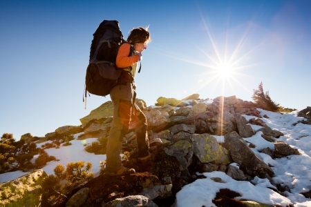 Hiker walking in autumn mountains. Caucasian model outdoors in natureの写真素材