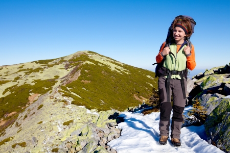 Hiker walking in autumn mountains. Caucasian model outdoors in natureの写真素材