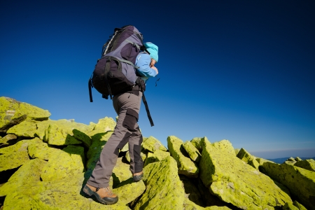 Hiker walking in autumn mountains. Caucasian model outdoors in natureの写真素材