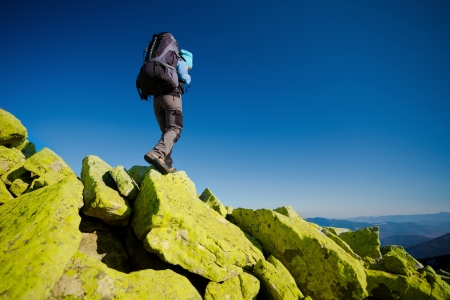 Hiker walking in autumn mountains. Caucasian model outdoors in natureの写真素材