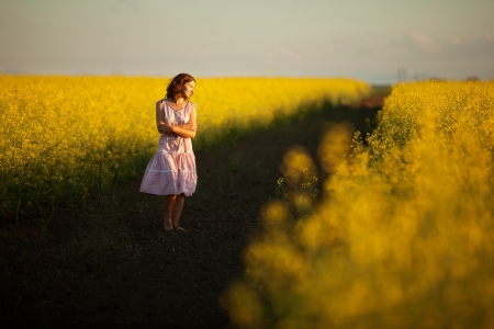 happy woman  in the yellow meadowの写真素材