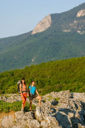 Two women is trekking in the Crimea mountains with backpacksの写真素材