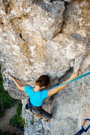 Woman practices in climbing at the rock in the Crimea mountainsの写真素材