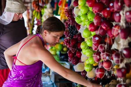 Woman chooses fruits at local market in Sri Lankaの写真素材