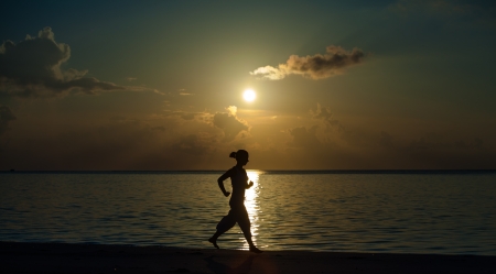 Caucasian woman jogging at the seashoreの写真素材