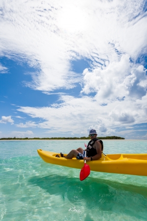 Young caucasian man kayaking in sea at Maldives の写真素材