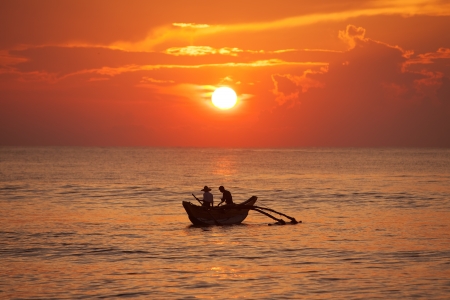 Scenic view at big lake in Sri Lanka with fishman in boatの写真素材