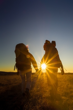 Hikers is walking on plateau in Crimea mountains during sunsetの写真素材
