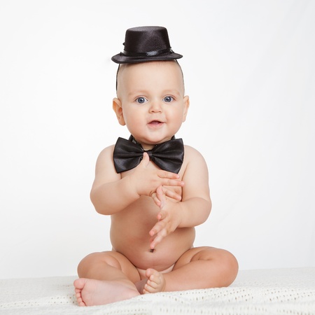 Caucasian baby boy plays with vintage camera an smiles joyfullyの写真素材